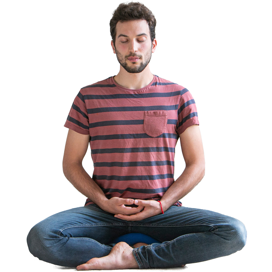 A young man in a striped t-shirt meditating