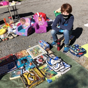 A young member and best salesperson at the Joyful Land Annual Garage Sale