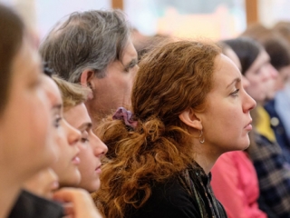 Courses_Saturday_Gallery4 A woman listening closely at a Saturday Morning Course