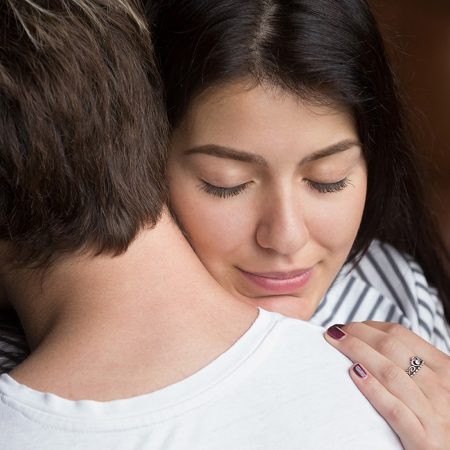 Woman hugging partner with a look of happiness