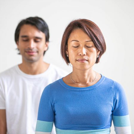 Young woman and man meditating